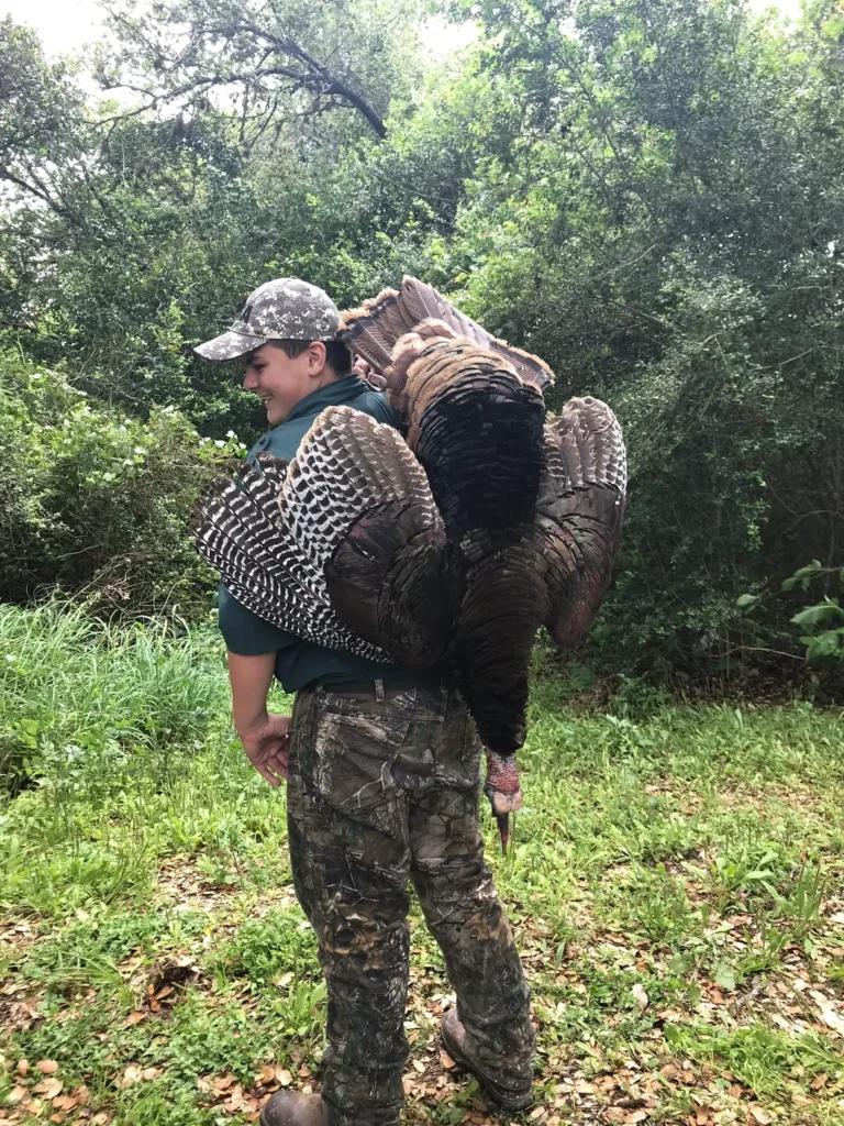 A man holding an animal in his arms.