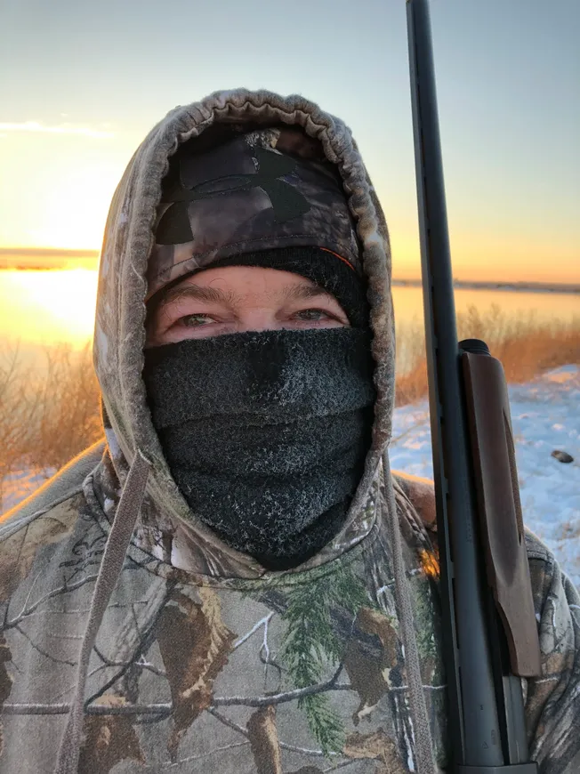 A person in camouflage holding a gun