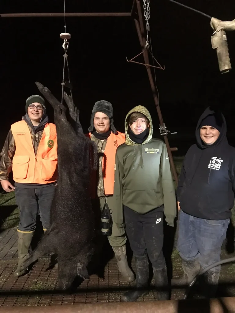 A group of people standing around a bear.