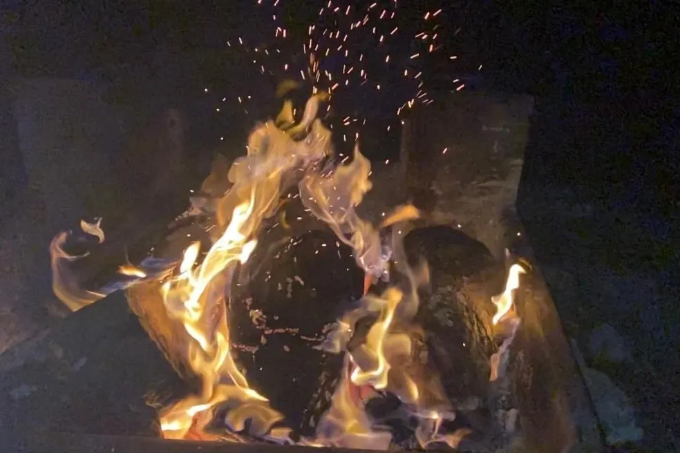 A fire with flames and smoke coming out of it.