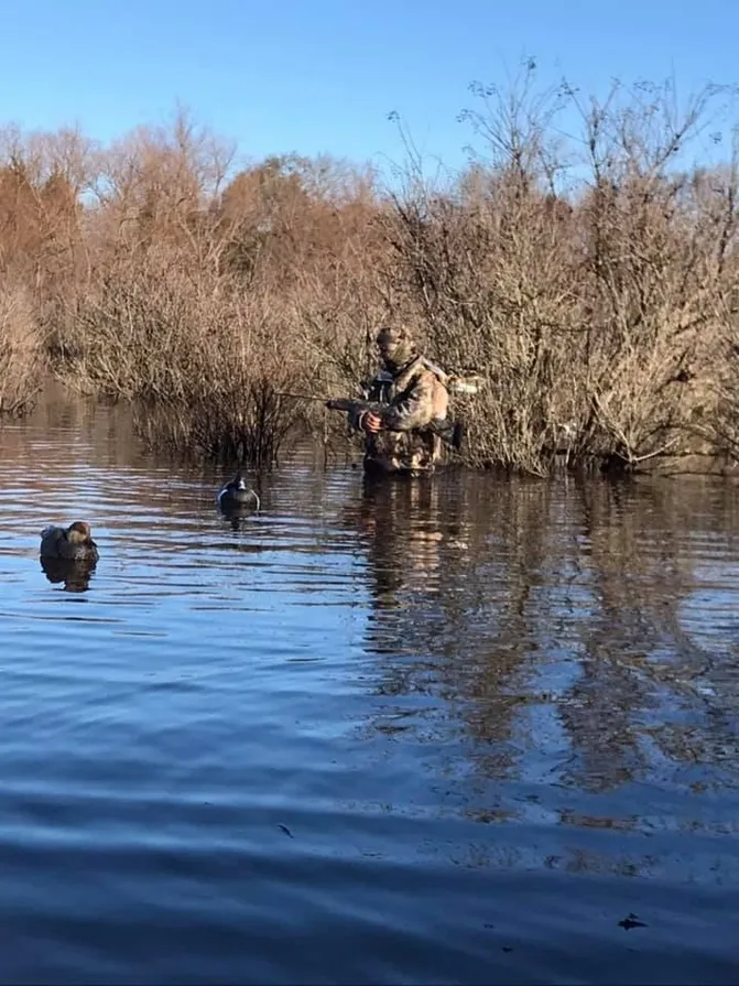 A man and dog in the water.