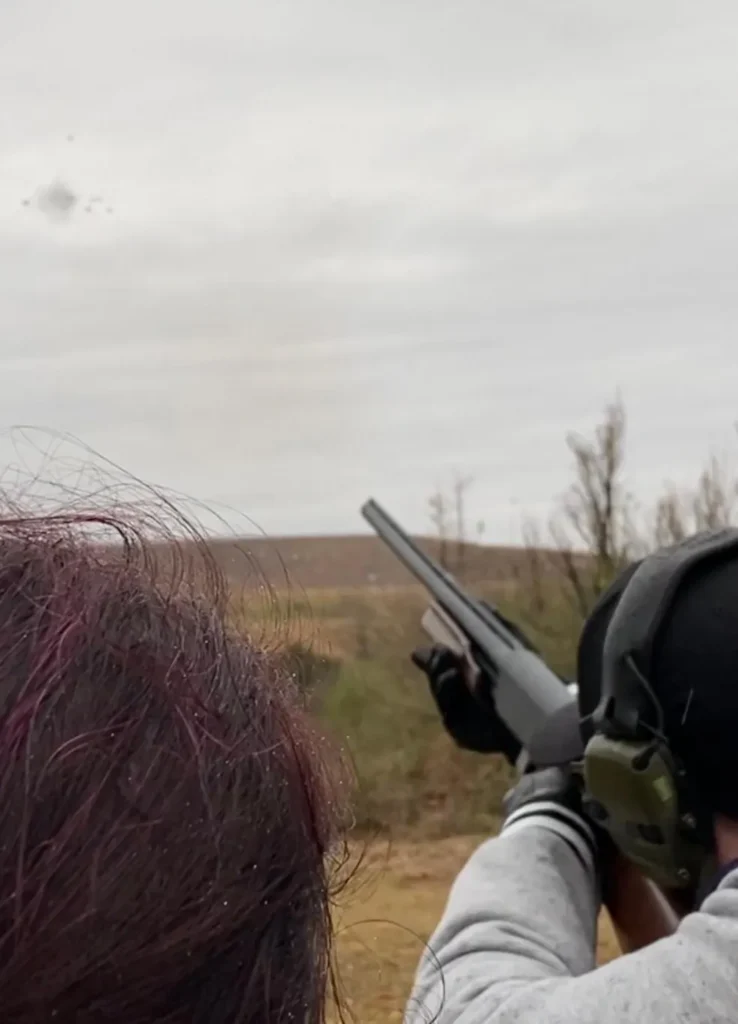 A person holding two guns in their hands.