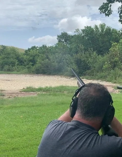 A man is holding two guns in his hands