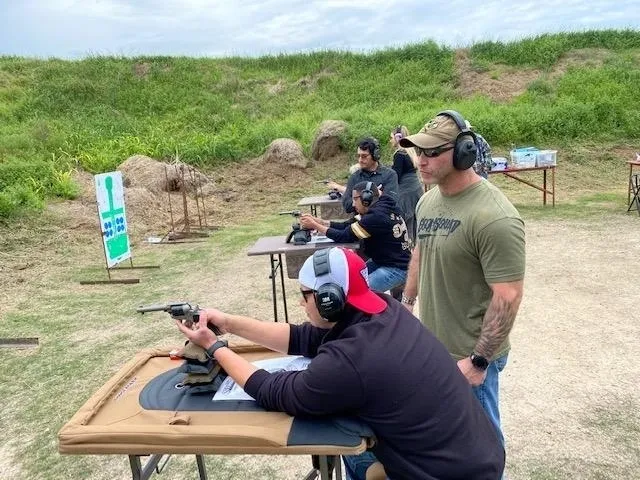 A group of people are practicing shooting at the range.