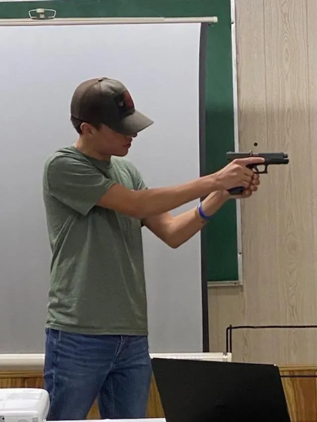 A man holding a gun in his hand.