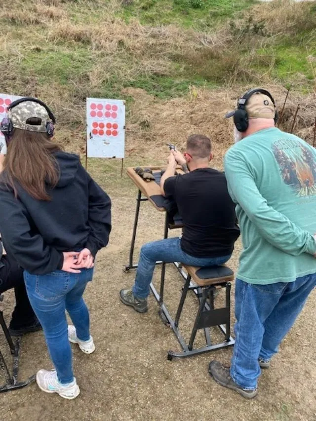 A group of people standing around a target.