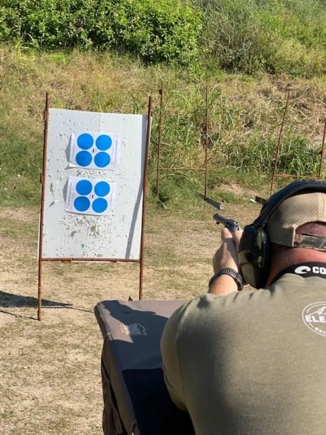 A man is aiming at a target with his rifle.