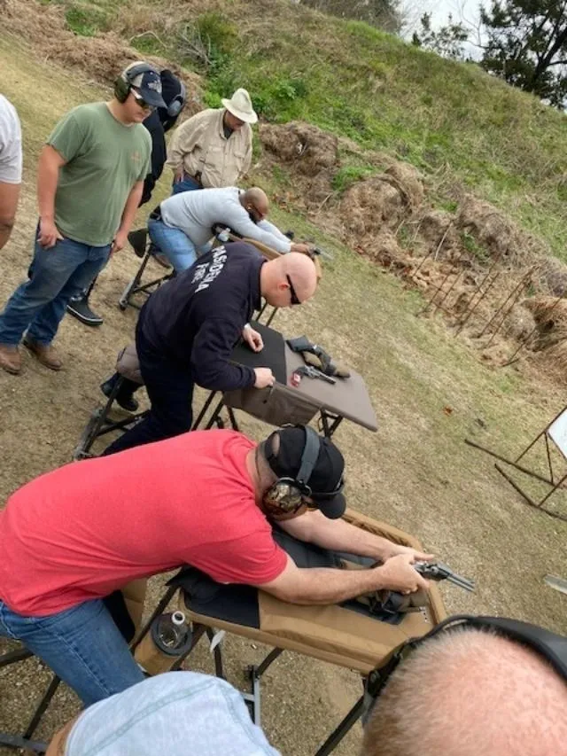 A group of people standing around a table.