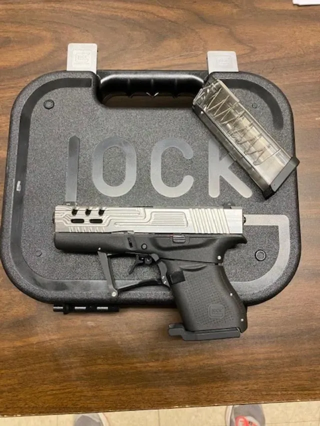 A gun that is sitting in a case.