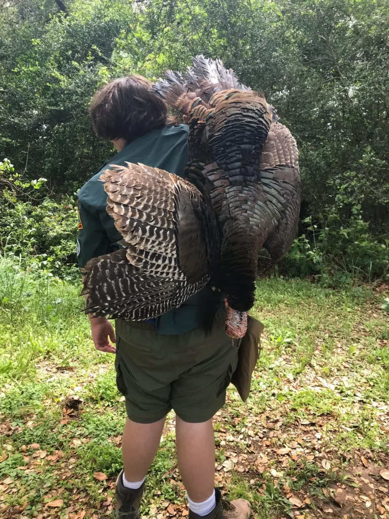 A man holding an animal in his arms.