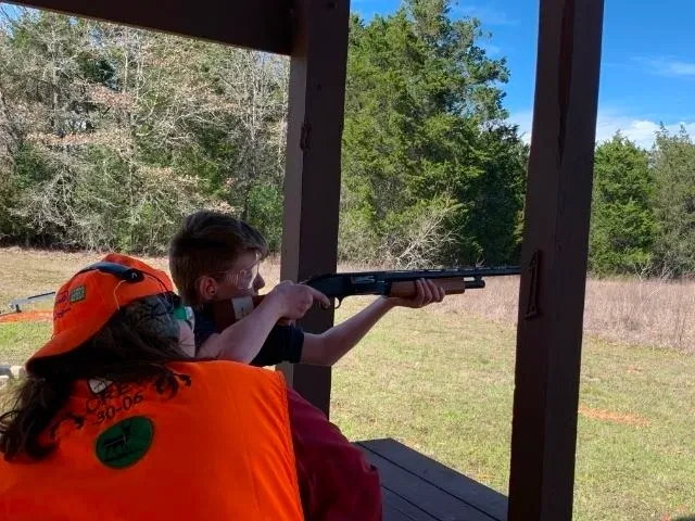 A man and woman are shooting at an event.