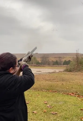 A woman is holding a gun in her hand