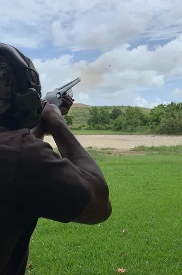 A man holding two guns in his hands.