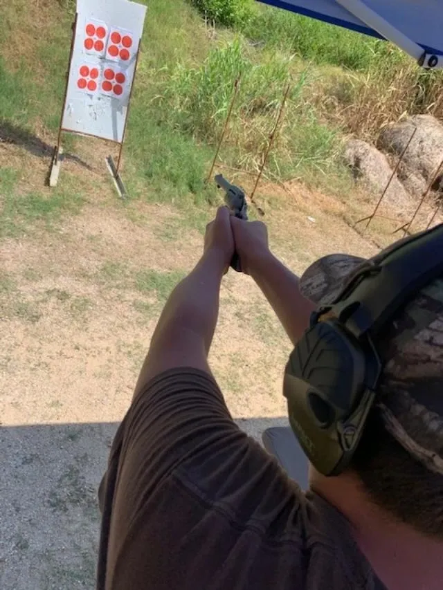 A man holding a gun in his hand.