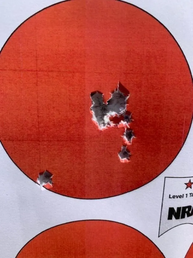 A red target with bullet holes in it.