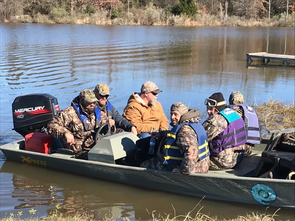 A group of people in a boat on the water.