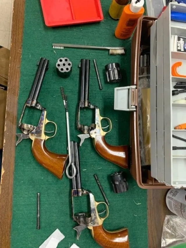 A table with some guns and other items on it