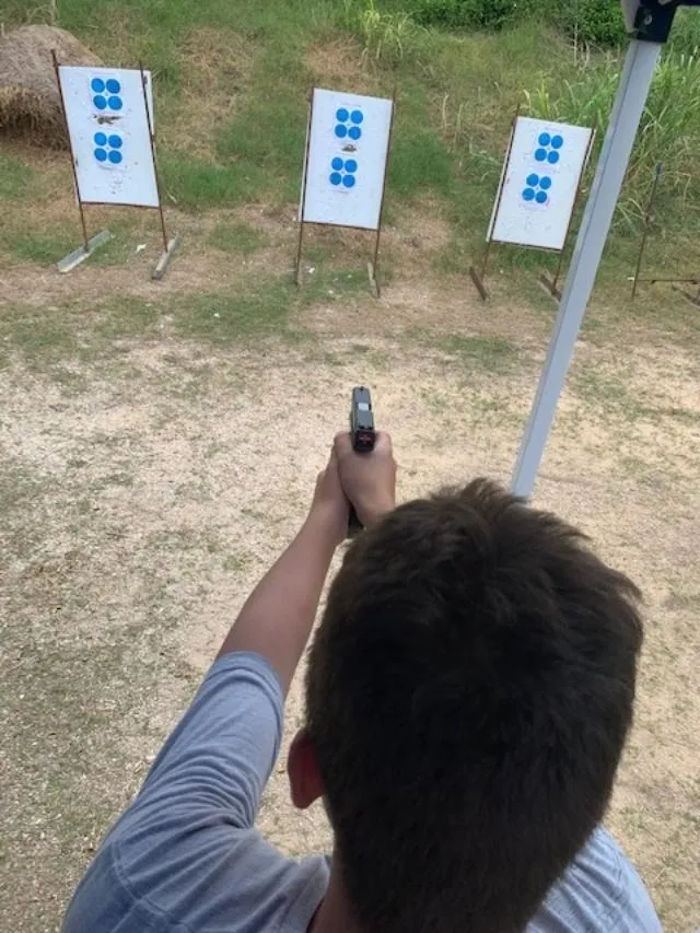 A man holding a gun up to the air