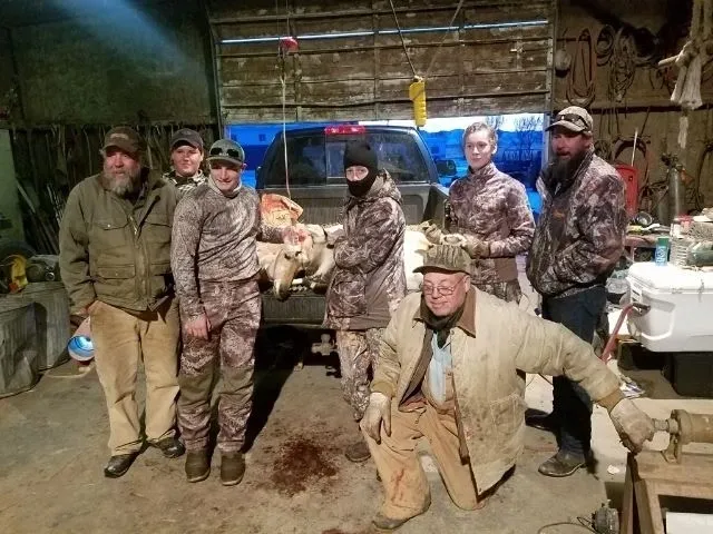 A group of men in camouflage standing next to each other.