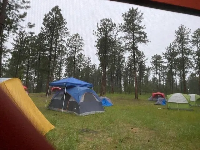 A group of tents in the middle of a field.