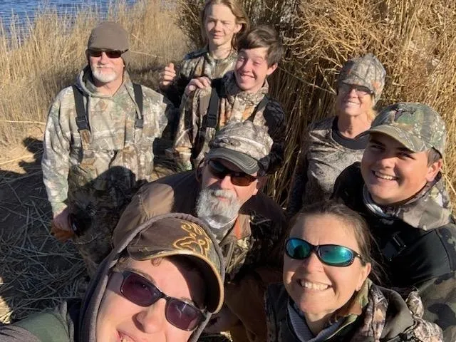 A group of people in camouflage gear posing for the camera.