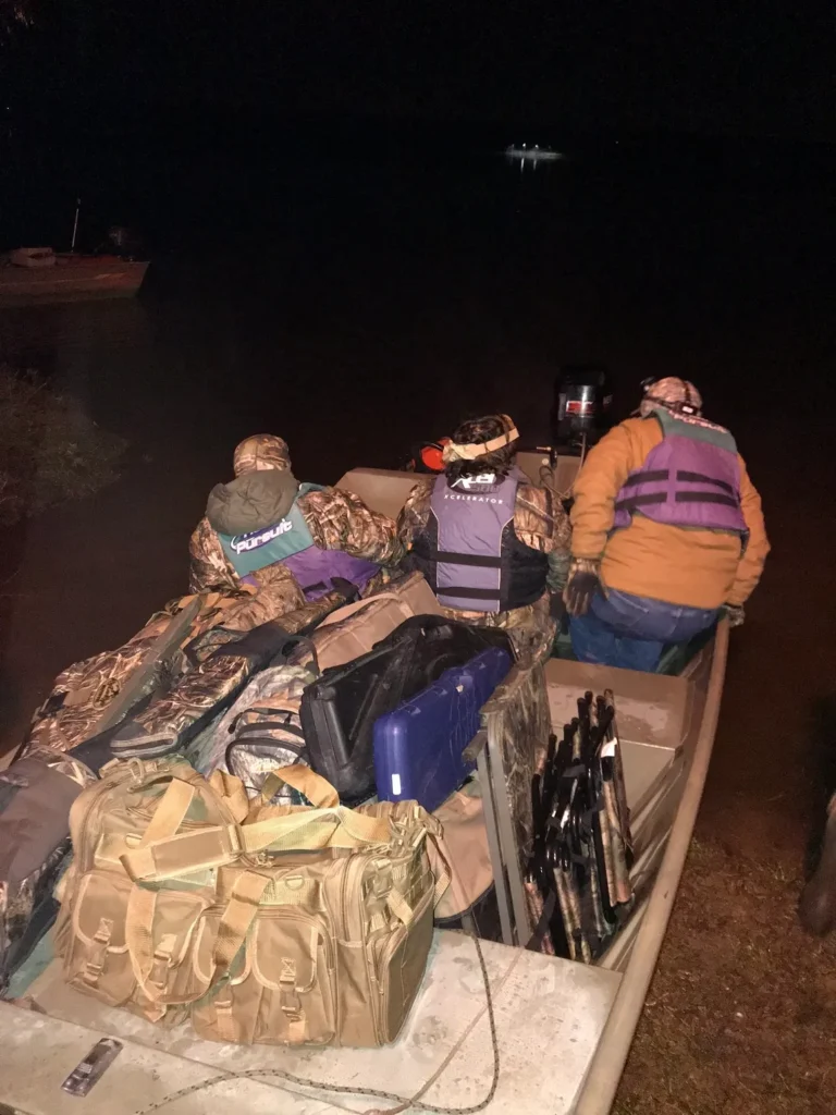A group of people in a boat with luggage.