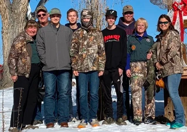 A group of people standing in the snow.