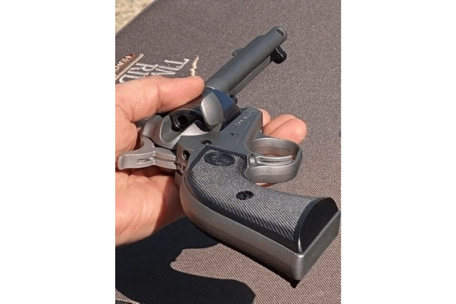 A person holding a gun with keys in it.
