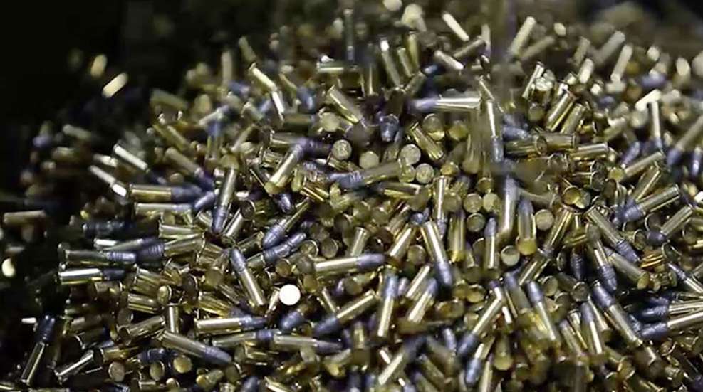 A pile of brass bullets sitting on top of each other.
