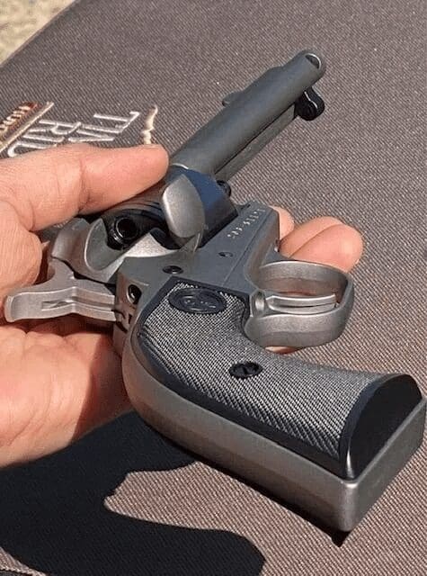 A person holding a gun with keys in it.