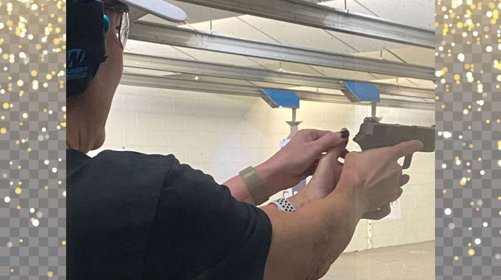 A man holding a gun in his hand.