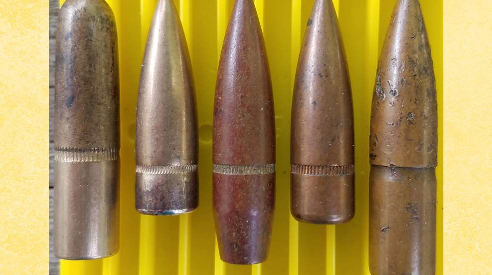 A row of bullets sitting on top of a yellow table.