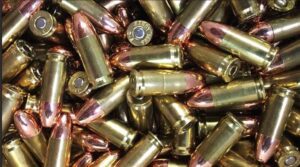 A pile of 9 mm bullets sitting next to each other.