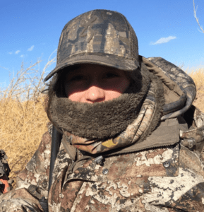 A man in camouflage gear with a beard.