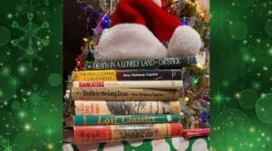 A stack of books with santa hat on top