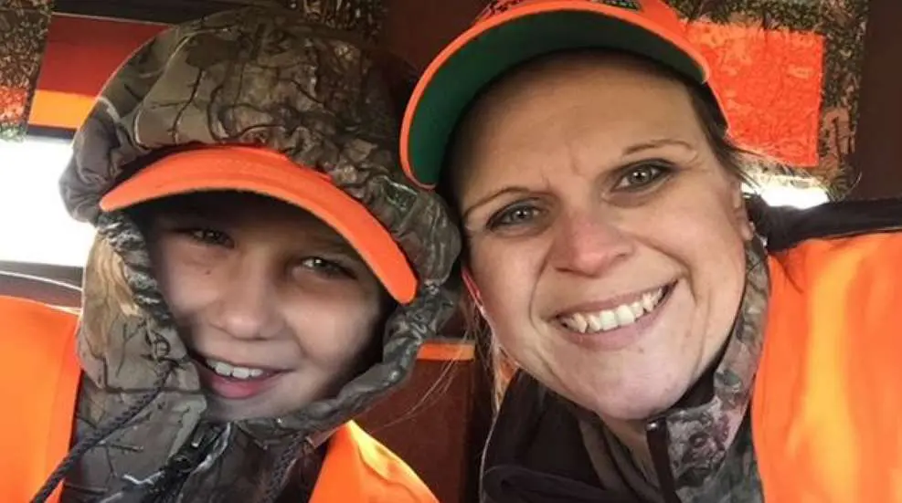 A woman and child wearing orange hats