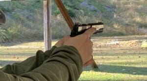 A person holding a gun in their hand.