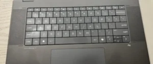 Close-up of a laptop keyboard and touchpad area.