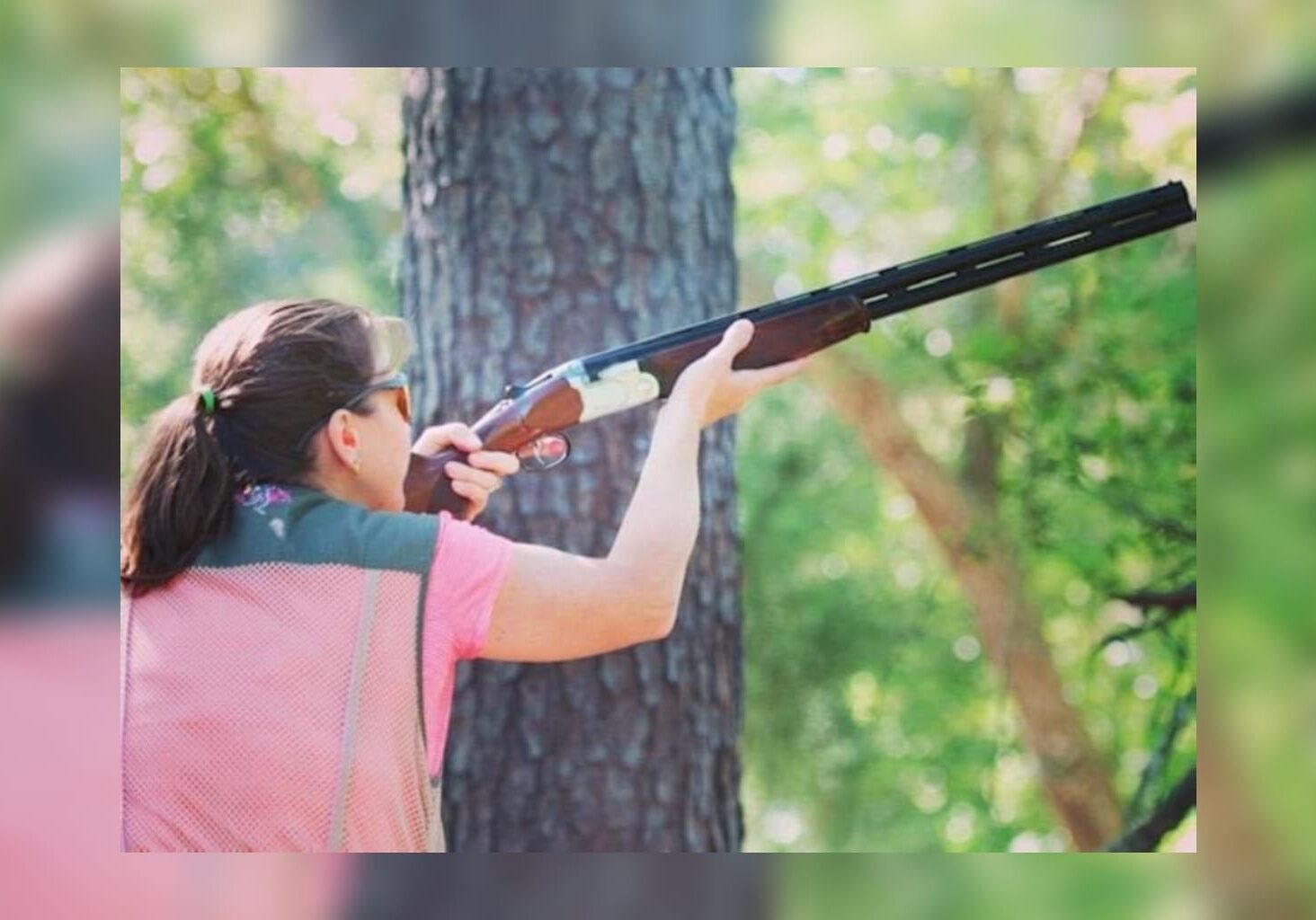 A woman is holding a gun in her hand.
