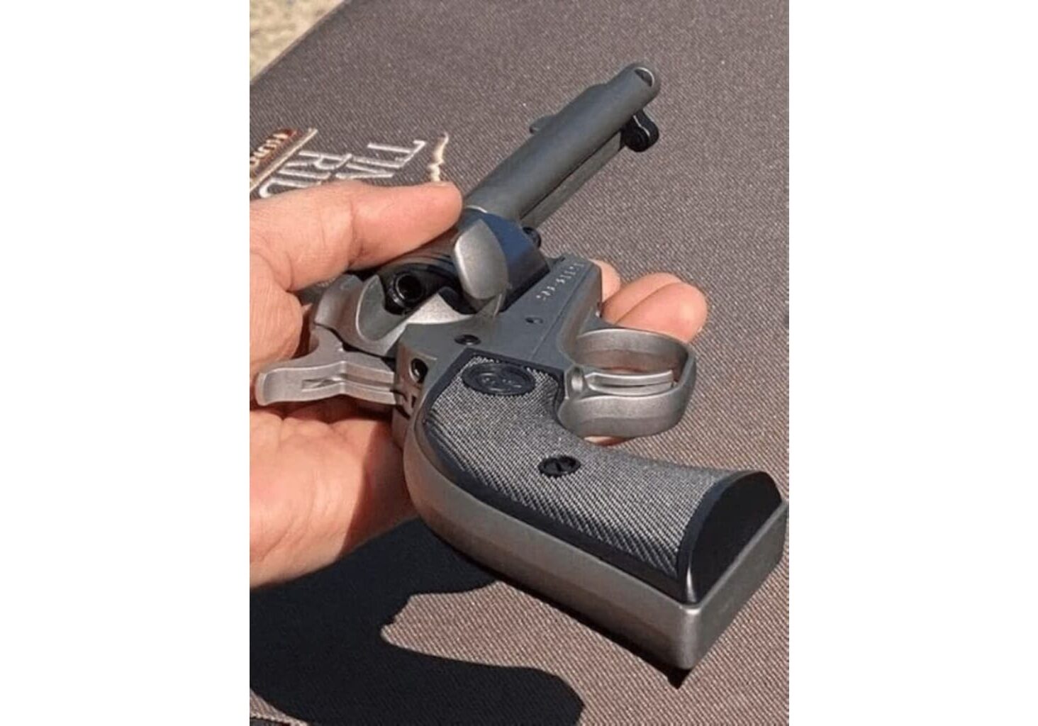A person holding a gun with keys in it.
