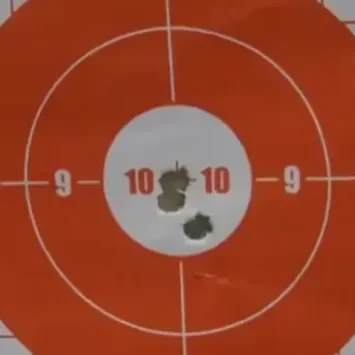 A target with bullet holes in it and the number 1 0-9.