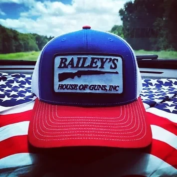 A red, white and blue baseball cap with the name bailey 's house of guns inc.